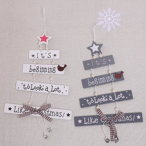 Two-piece wooden Christmas tree ornaments with white and grey stars and metal bells