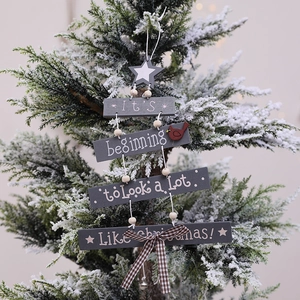 Gray four-tier wooden Christmas sign with star, red bird and bow on snowy tree branch
