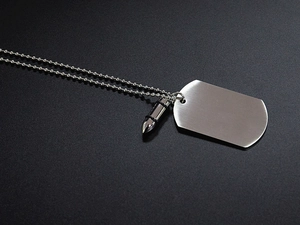 Detail of brushed titanium steel dog tag and bullet pendant on a silver ball chain