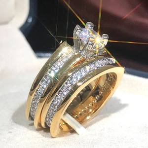Macro shot of AAA luxury gold plated engagement bridal ring set with sparkling zircons