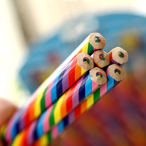Macro shot of hexagonal rainbow pencil tip showing multi-colored lead core