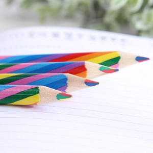 Macro shot of 4-color rainbow pencil tip with vibrant mixed lead on wood texture