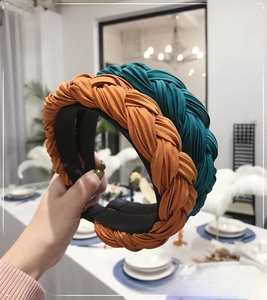 Detail of orange and dark green pleated fabric braided headbands for women