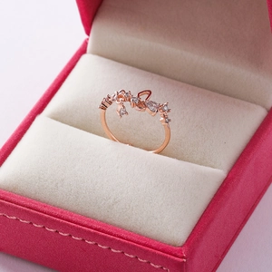 Detail shot of rose gold flower ring with cubic zirconia in a jewelry box