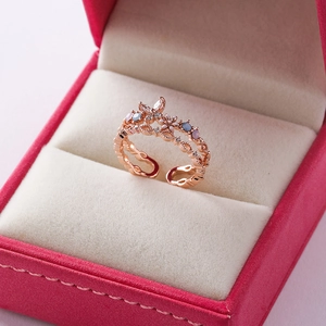 Macro view of a rose gold open ring with floral butterfly charms and colorful zircons