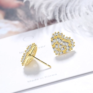 Golden heart-shaped stud earrings with sparkling pavé zircons on white card