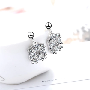 Sparkling silver square zircon stud earrings with geometric design on white ceramic