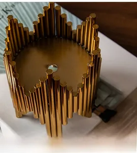 Detail of a luxury gold metal sculpture base with a polished mirror finish for home decor