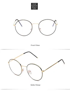 Detail view of round metal glasses in gold and black with clear lenses and slim frames