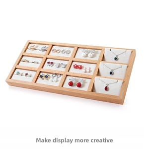 Detail view of beech wood jewelry tray with 12 compartments and soft white velvet lining