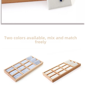 Macro detail of 12-slot beech wood jewelry display tray with grey and white velvet liners