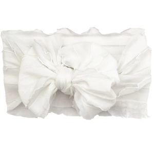 Detail of white chiffon lace headband for babies featuring a layered ruffled bow