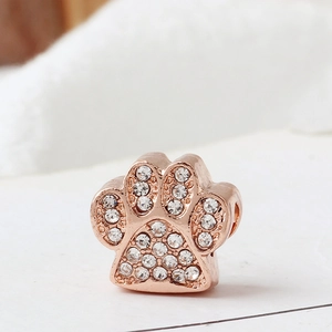 Detailed view of rose gold animal paw charm with sparkling crystal rhinestones