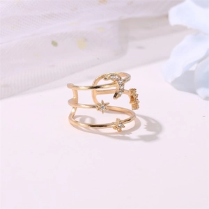 Detail of gold-plated triple layer open ring with crystal moon and star motifs