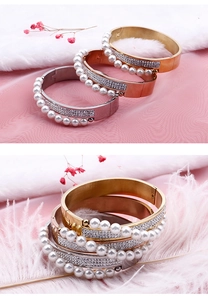 Detail of cross pattern pearl and diamond bracelets in gold, silver, and rose gold finishes