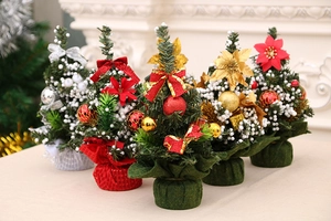 Detailed view of mini Christmas trees with colorful bows, baubles, and snow textures