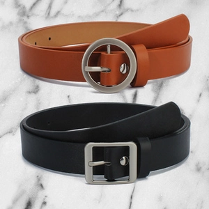 Close-up of black and brown elastic waist belts with round and square metal buckles