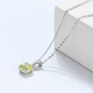 Detail of 925 sterling silver necklace with a brilliant yellow faceted zircon pendant