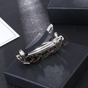 Detail of vintage steampunk hair clip with dark tortoiseshell pattern on a black box
