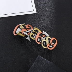 Macro detail of steampunk style hair clip featuring interlocking alloy metal numbers