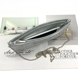 Macro shot showing large smartphone storage capacity in silver sequin metal clutch bag