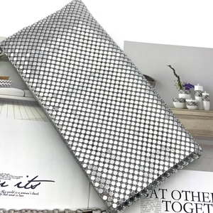 Close-up of interlocking silver metal sequin mesh and detachable chain for dinner clutch