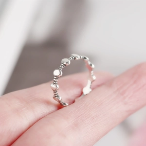 Close-up of a minimalist 925 silver ring featuring linked circular disc elements
