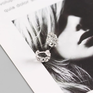 Detailed close-up of geometric S925 sterling silver chain link earrings with micro pavé diamonds