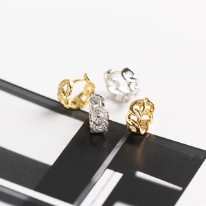Detailed macro view of S925 sterling silver chain link hoop earrings in gold and silver