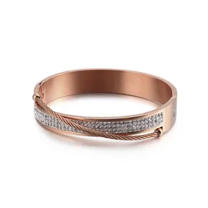 Rose gold plated stainless steel bracelet featuring double-row crystals and woven metal wire