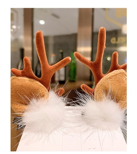 Detail of Christmas reindeer antler hair clips with plush balls on display card