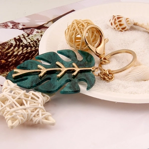 Tropical monstera leaf keychain with gold metal veins and green marble finish