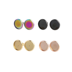 Macro view of 4 pairs of round stainless steel earring studs in four different colors