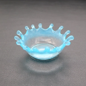 Macro shot of crown shaped water droplet resin mold with blue gradient finish