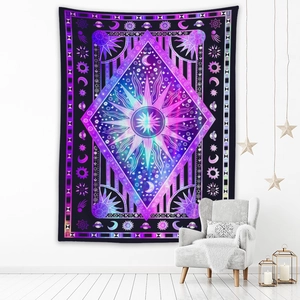 Detail of bohemian sun and moon astrology tapestry on a white wall in a cozy bedroom setup