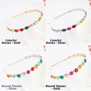 Detail view of colorful rhinestone headbands in oval and round shapes with gold and silver base