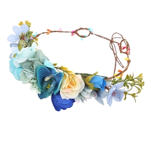 Detailed view of floral bridal crown with blue and yellow silk flowers and brown twigs