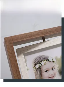 Detail of creative rotating 6-inch wooden photo frame with walnut and light wood grain finish