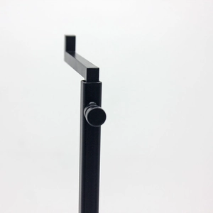 Detail of black metal display stand with L-shaped top and circular adjustment knob