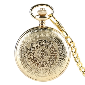 Detail of vintage gold pocket watch featuring intricate floral engraving and matching chain
