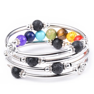 Detail of multi-layer wrap bracelet featuring seven chakra natural stones and silver tubes