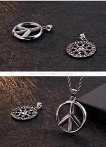 Detail of vintage Viking sun flower and peace sign pendants with stainless steel chains