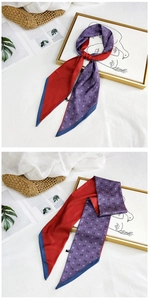 Elegant purple silk scarf with horse print styled on a woven bag and magazines