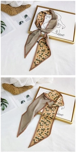 Detail of double-sided silk scarf with floral pattern and checkered design for women