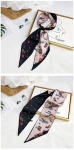 Close-up of floral long silk scarf with two-tone black and pink flower patterns