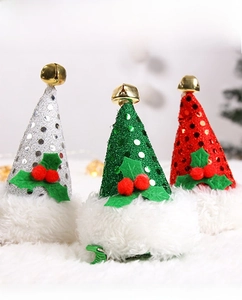 Close-up of sequined mini Christmas hat clips in red, green and silver with gold bells
