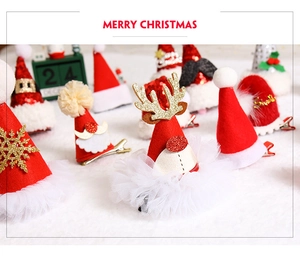 Detailed view of red Christmas hair clips featuring sequins, reindeer antlers and tulle veil