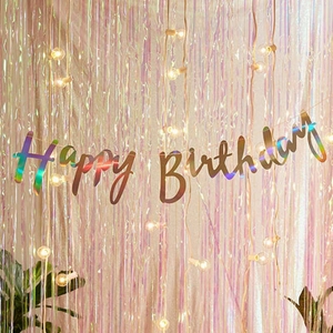 Iridescent laser Happy Birthday banner with rain curtain and warm string lights background