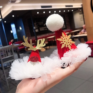 Christmas hair clips featuring red reindeer antlers and Santa hat with gold glitter accents