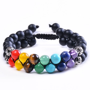 Detail of adjustable double-layer woven bracelet with black lava and seven chakra beads